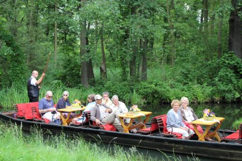 a group of people sitting at tables on a boat at KrabatResidenz - Apartmenthaus in Burg