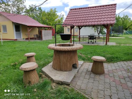 a bird feeder sitting on top of some logs at Rákóczi Vendégház in Poroszló