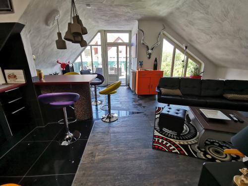 a kitchen and living room with a couch and a table at Ferienwohnung "Kleine Nixe" in Jever