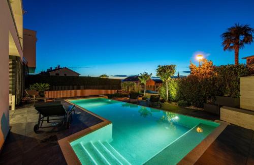 a swimming pool in the backyard of a house at Luxury Villa Ane in Malinska