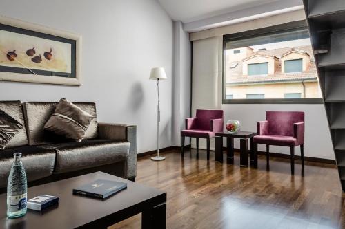 a living room with a couch and two chairs at Eurostars Reina Felicia in Jaca