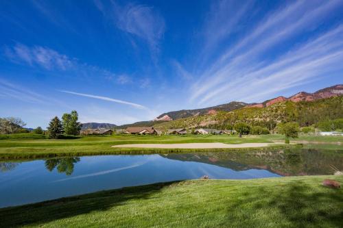 a view of a golf course with a pond at 95 Saint Andrews Circle in Hermosa