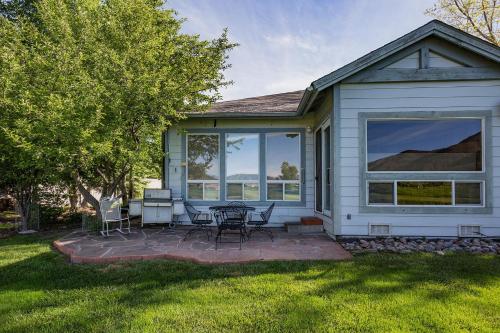 a house with a patio with a table and chairs at 95 Saint Andrews Circle in Hermosa