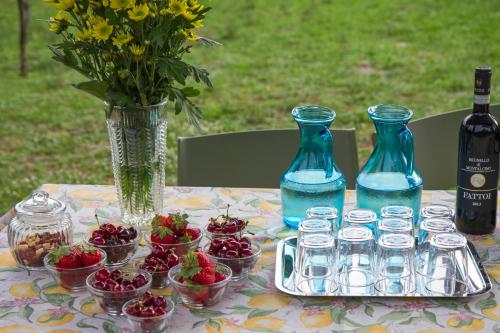 a table with a vase of flowers and a bunch of cherries at B&B PALAZZI in Florence
