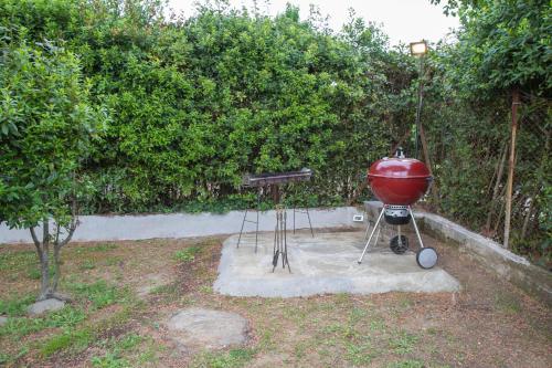 a barbecue grill on a stand next to a tree at B&B PALAZZI in Florence