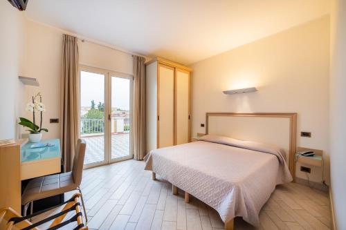 Postel nebo postele na pokoji v ubytování Hotel Il Gabbiano