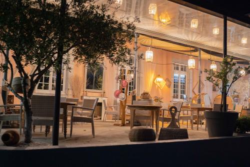 a store window with tables and chairs in it at BOUTIK Hotel O'Domaine in Chis