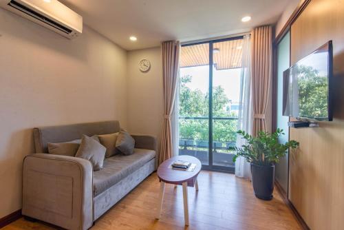 a living room with a couch and a table at 22Land Moon West Lake in Hanoi