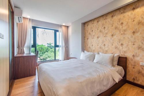 a bedroom with a large bed and a large window at 22Land Moon West Lake in Hanoi