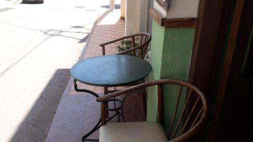 a table and chairs sitting on the side of a building at Hotel zakros rooms-restaurant in Zekros