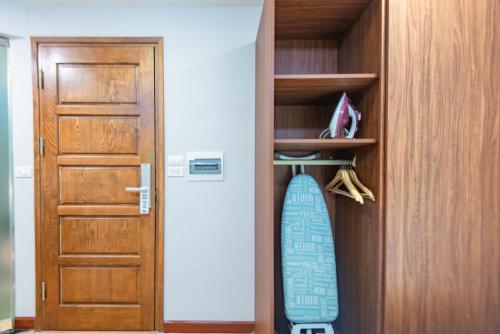 a surfboard is hanging on a shelf next to a door at 22Land Moon West Lake in Hanoi