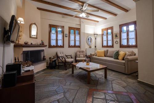 a living room with a couch and a table at Deja Blue in Mouresi
