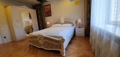 a bedroom with a bed and a dresser and a mirror at Cosy House Kaunas & Parking in Kaunas