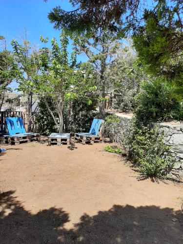 a group of blue chairs sitting in a park at Chaniotis Studios in Kalafatis