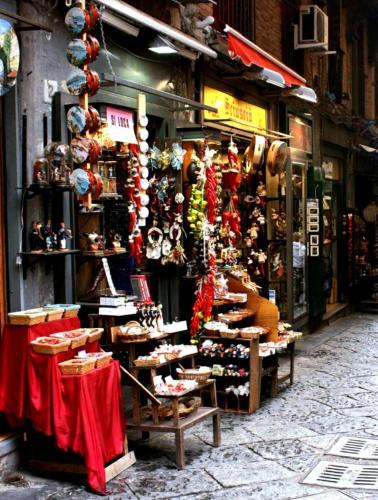 a store with a lot of items on display in a street at HOTEL CRISARI in Naples