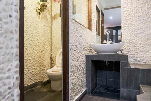 a bathroom with a sink and a toilet at RedDoorz near Waterboom Lippo Cikarang in Cikarang