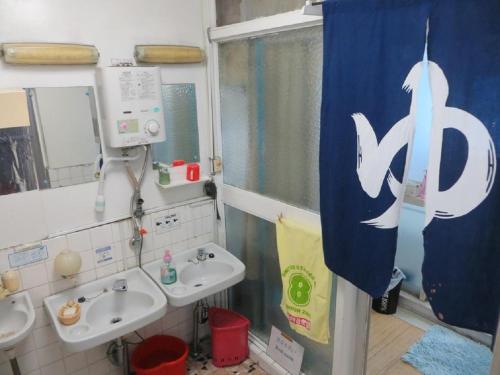 a bathroom with two sinks and a shower curtain at Komecho Ryokan / Vacation STAY 33206 in Imabari