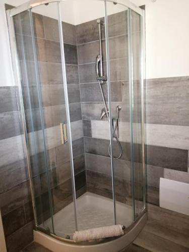 a shower with a glass enclosure in a bathroom at La grazia in qualche modo in Siniscola