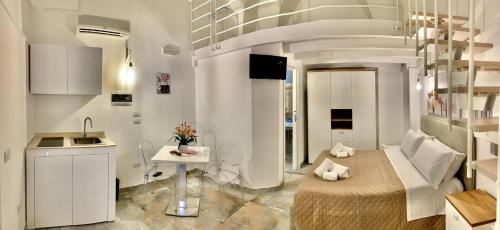 a kitchen and a living room with a bed and a sink at ZiaCO' in Leverano