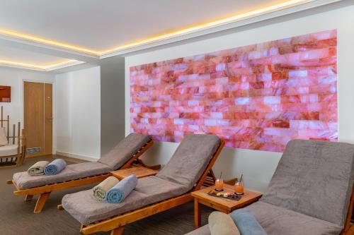 a room with two chairs and a painting on the wall at Hotel Annapurna in Courchevel