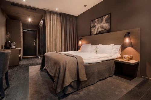 a hotel room with a large bed in a room at The Lamp Hotel & Spa in Norrköping