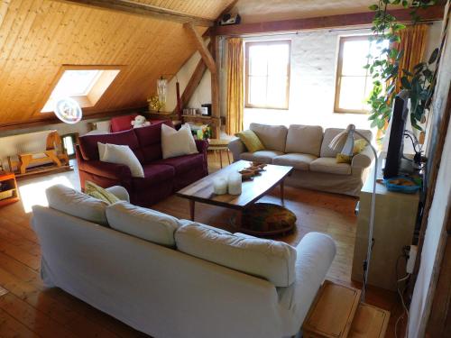 a living room with a white couch and a table at Holiday Home Weisten 5 in Burg-Reuland