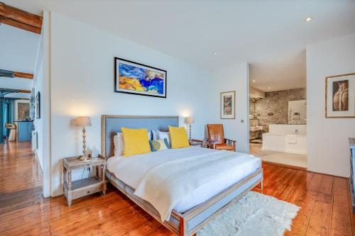 a bedroom with a large bed with yellow pillows at Royal William Yard Apartments in Plymouth