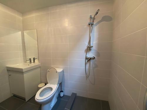 a small bathroom with a toilet and a shower at Central Suites Perikleous 53 Down Town Nicosia By Platform 357 in Nicosia