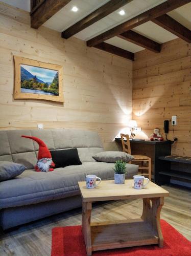 a living room with a couch and a table at Logis Hôtel Le Vétiné in Le Valtin