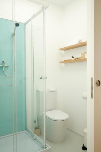 a bathroom with a toilet and a glass shower at Monte Velho Retreat Centre in Aljezur