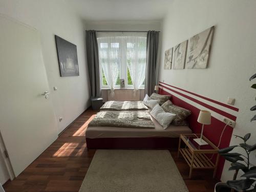 a bedroom with two beds and a window at LE-Citywohnung-II in Leipzig