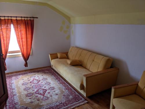 a living room with a couch and a rug at Village Home - Kuca u prirodi in Tešanj