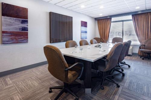 a conference room with a large table and chairs at Wingate by Wyndham Tinley Park in Tinley Park