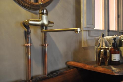 a kitchen sink with a faucet on a table at Maison du Flâneur in Chioggia