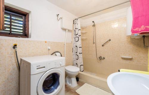 a bathroom with a washing machine and a toilet at Apartment Sveti Jakov 37 in Sveti Jakov