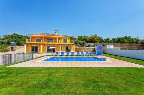a house with a swimming pool in a yard at Villa Ribeiro Tomas by Villa Plus in Loulé