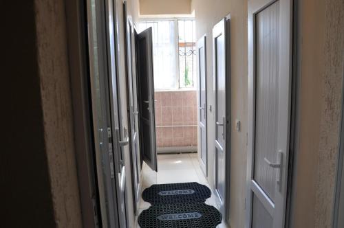 a hallway with doors and a rug on the floor at Hostel - NS Prestige in Shymkent