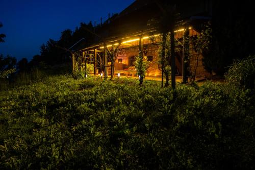 a house lit up at night with lights at Zidanica Lackner in Črnomelj