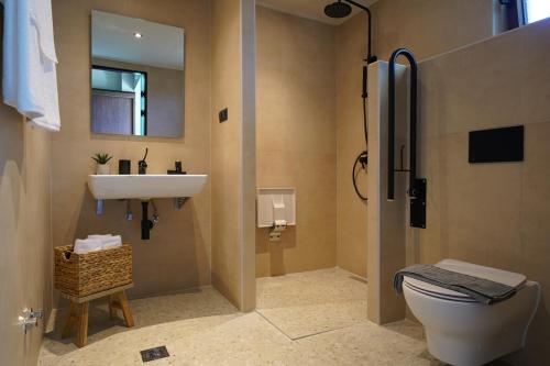 a bathroom with a sink and a toilet at KYVO Experience in Skala Potamias