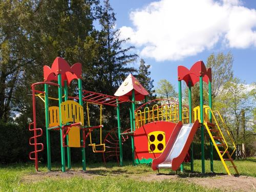a playground with a slide in a park at Коттедж на базе отдыха у реки с. Кудашевка in Kudashevka