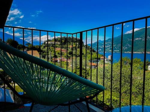a green bench sitting on top of a balcony at Charming Bellagio Boutique Hotel in Bellagio