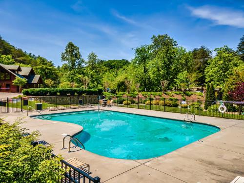 a swimming pool in a yard with a fence at FALL SPECIAL! NERF Party, Pool, HotTub, Pet Friendly in Sevierville