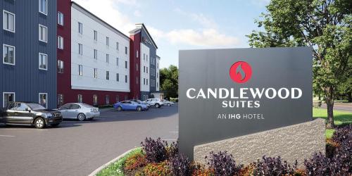 a sign in front of a building with cars parked at Candlewood Suites - Lexington - Medical District by IHG in Lexington