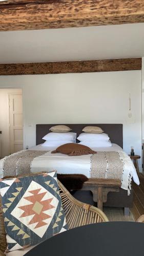 a bedroom with two beds and a bench at B&B No. 42 in Valkenburg