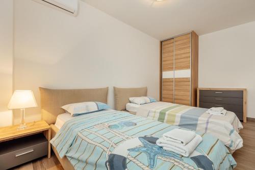 Ένα ή περισσότερα κρεβάτια σε δωμάτιο στο Doxa M Apartments