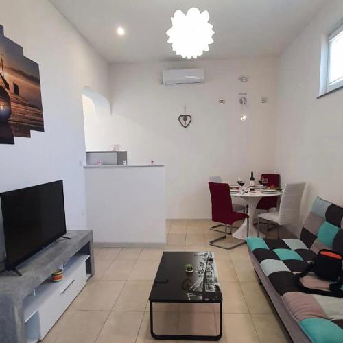 a living room with a couch and a table at Apartment Fran in Sonković