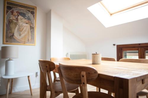 a dining room with a wooden table and chairs at Casa Pelaire Biescas in Biescas