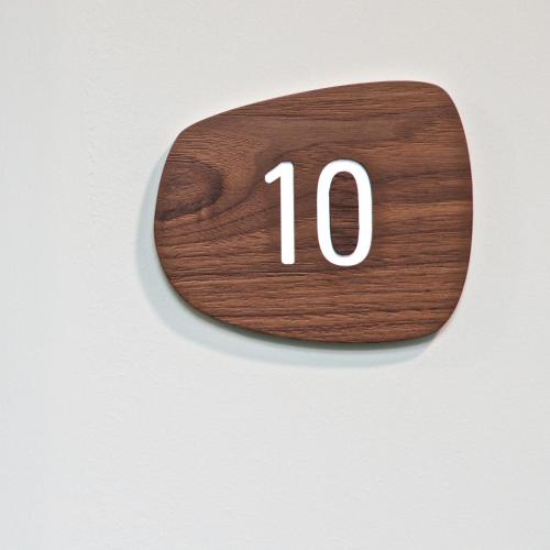 a wooden plaque with the number on a wall at Telegraph Hotel - Coventry in Coventry