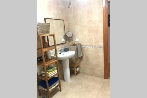 a bathroom with a sink and a mirror at Apartament amb parking privat a St Joan de les Abadesses in Sant Joan de les Abadesses