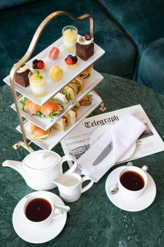a tray of food and two cups of coffee on a table at Telegraph Hotel - Coventry in Coventry